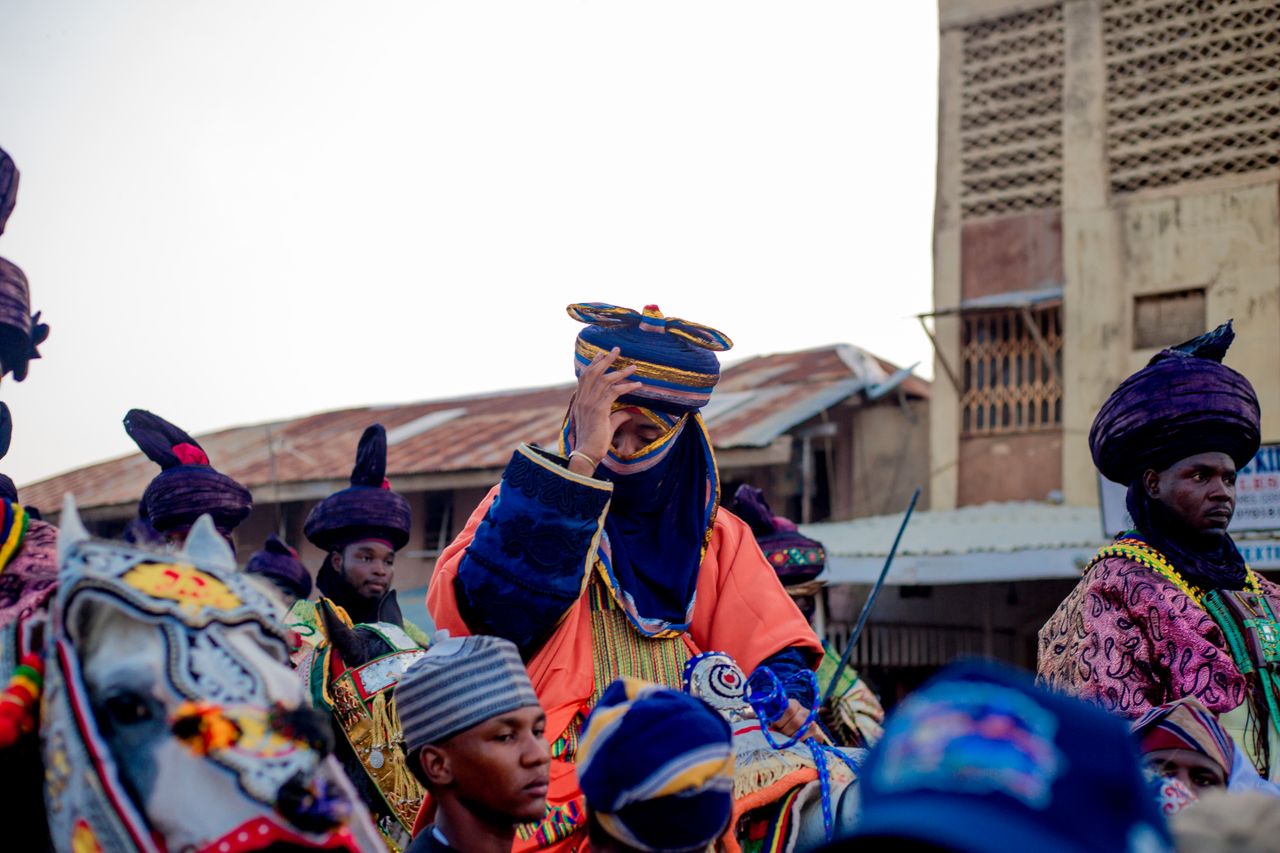 Colorful display during a traditional festival in Katsina, Nigeria, featuring ornate clothing and horse decorations.
